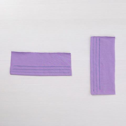 Two scrap pieces of lilac jersey with three rows each of test stitches.