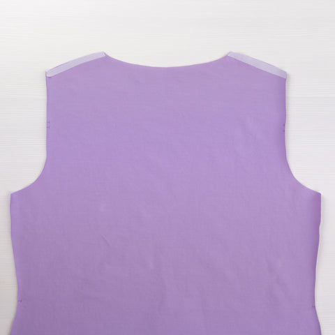 Bodice piece of a tee shirt cut in lilac jersey with knit interfacing at the shoulders.