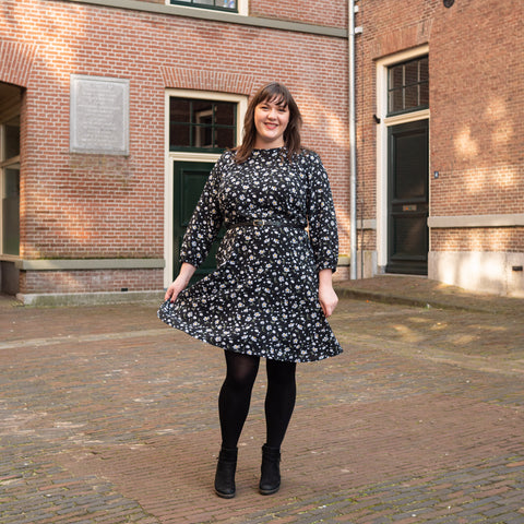 Full body photo of Bri wearing her black floral Forget-me-Not Patterns Valerie Raglan Dress