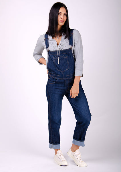 Ladies denim dungarees paired with grey blouse and white pumps.