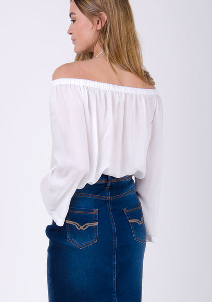 Indigo denim pencil skirt paired with light off-the-shoulder blouse.