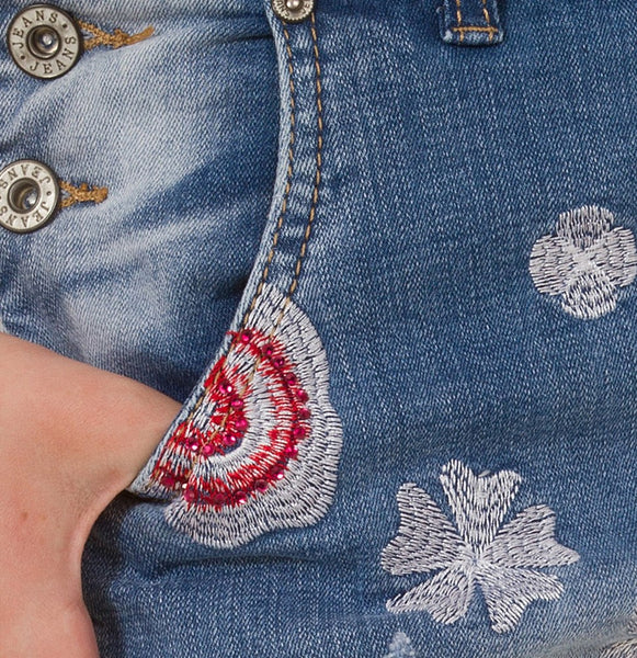 Embroidered denim dungarees close-up.