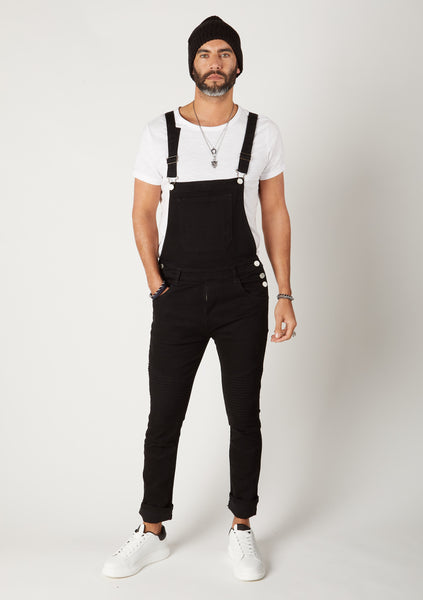 Men's black super skinny dungarees from Dungarees Online, paired with white t-shirt and black beenie hat.
