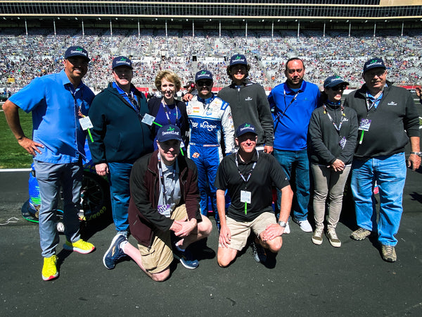 Ricky Stenhouse Jr. and the SweetLeaf Team pose for a photo at the Nascar track.