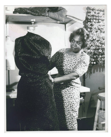 Zelda Wynn Valdes drapes a dress in her workroom.