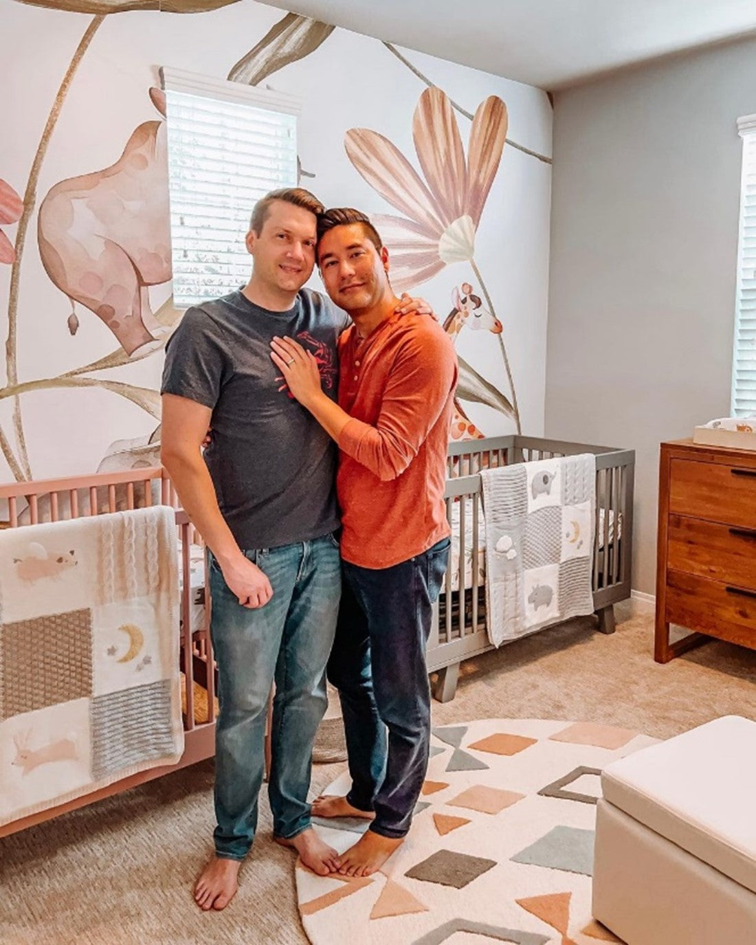 Bryan and Chris in their safari-themed nursery, featuring the babyletto Hudson Crib in Grey