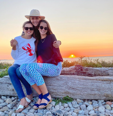 Three girls enjoying sunset in Fishers Island, NY wearing Charleston Shoe Co. navy wedges