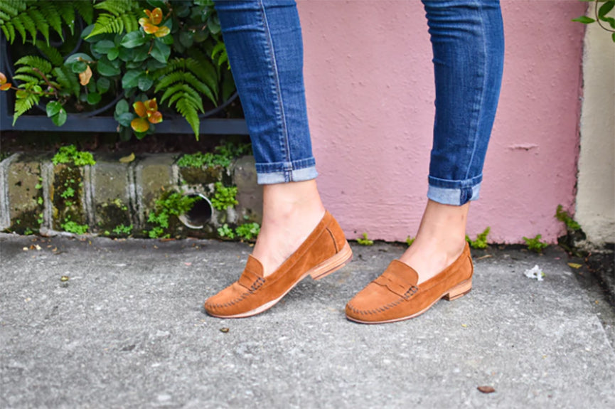a close up of a woman wearing stonos leather loafers