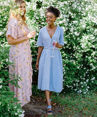 pair of women in stylish outfits