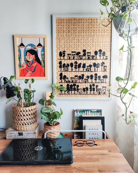 Work table with stenciled art on bamboo mat frame on the wall