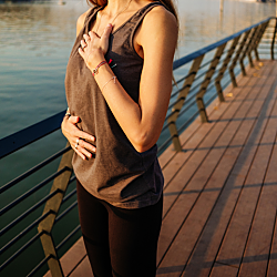 Image of woman standing on boardwalk breathing.