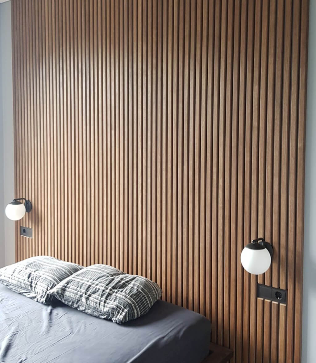 Fluted wall panels behind a bed