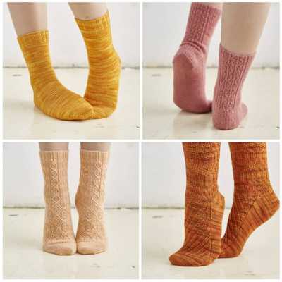 Four different pairs of socks made using Socks Yeah yarn