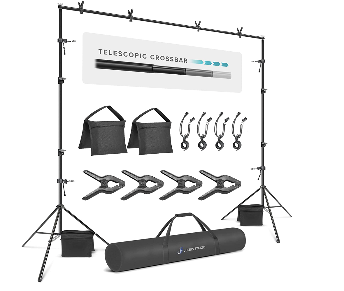 A photography backdrop stand with weights, bags, and other accessories