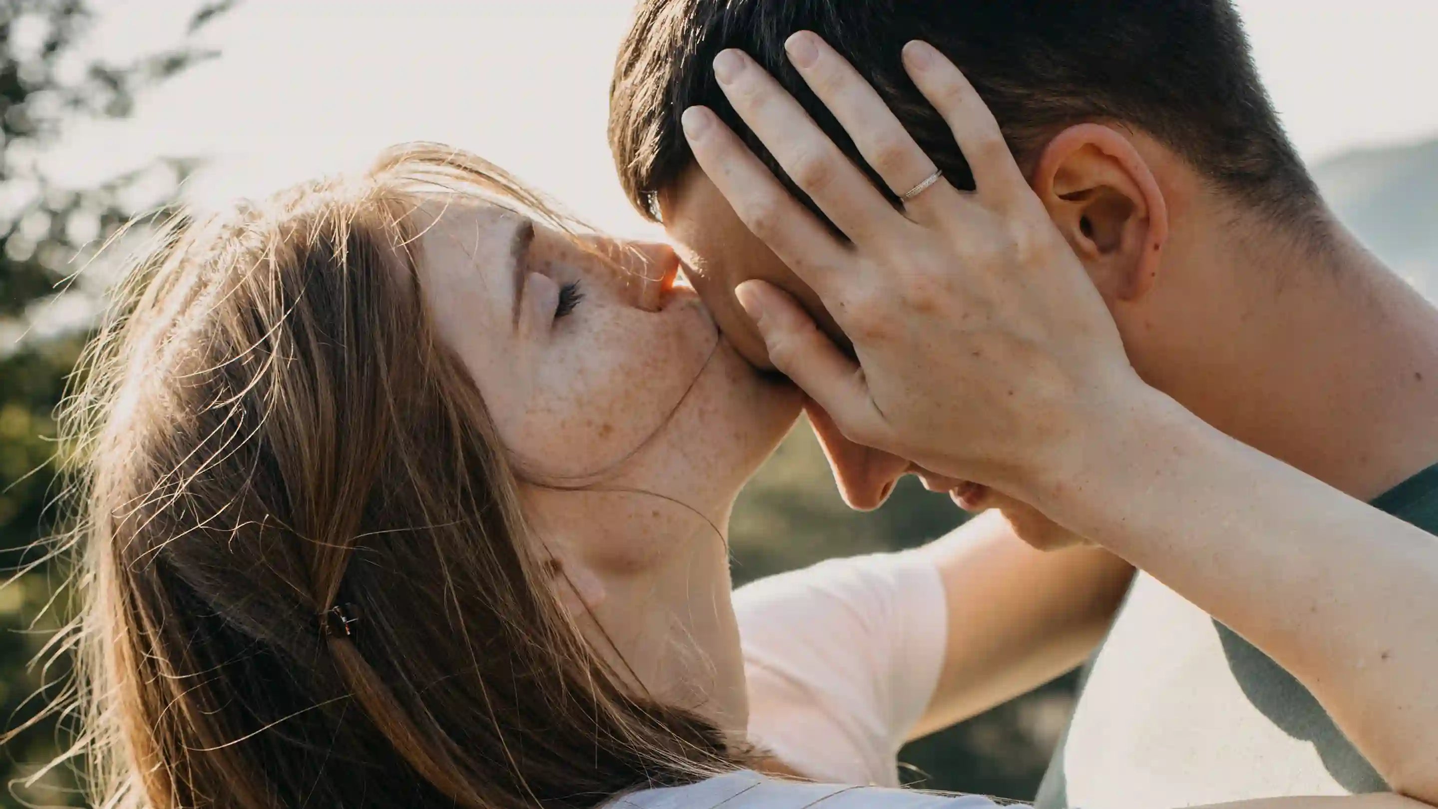 a woman kissing a man's forehead