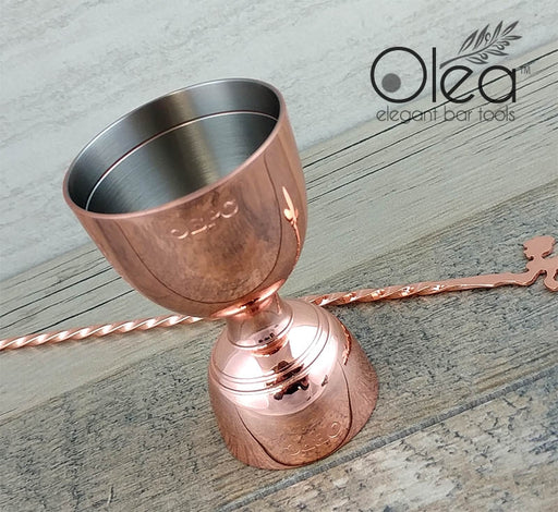 https://cdn.shopify.com/s/files/1/0096/0276/0755/products/olea-bell-jigger-copper-bpc_512x470.jpg?v=1686315480