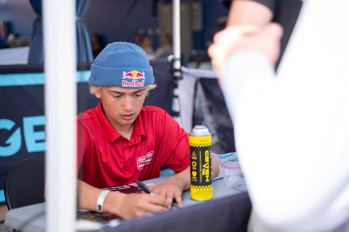 Kelana Humphrey signing posters at Invictus Speed Crew 