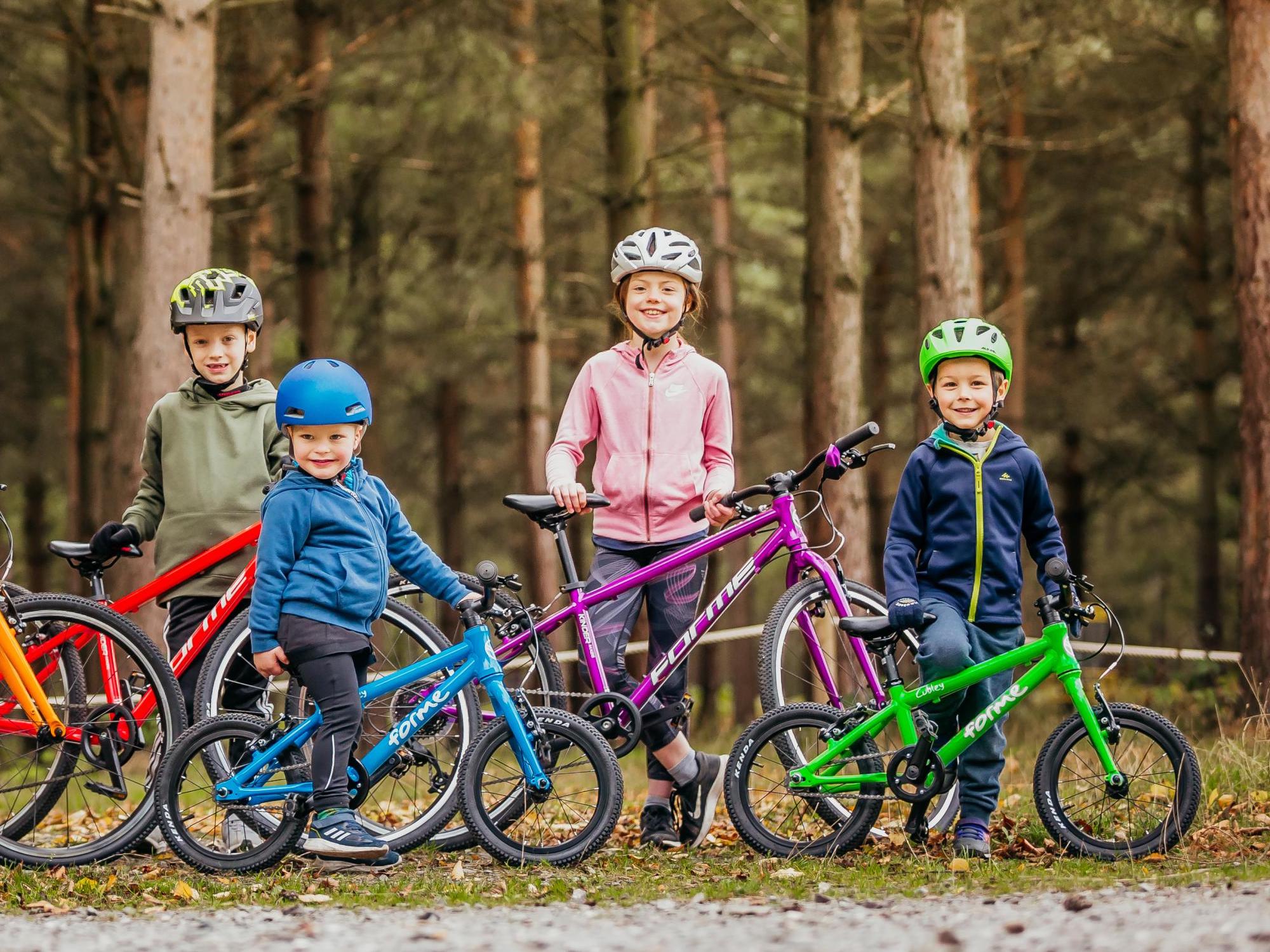 children leaning on bikes