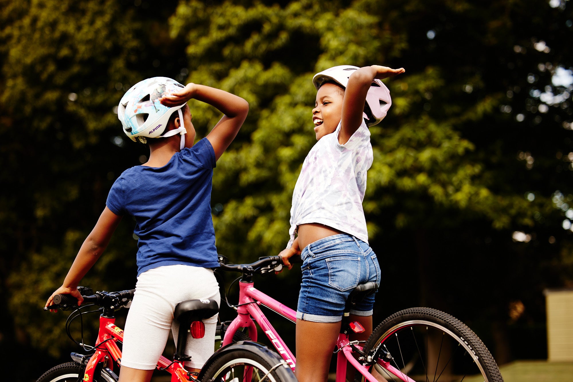 two children on bikes high diving