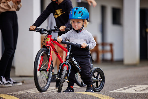 child on balance bike