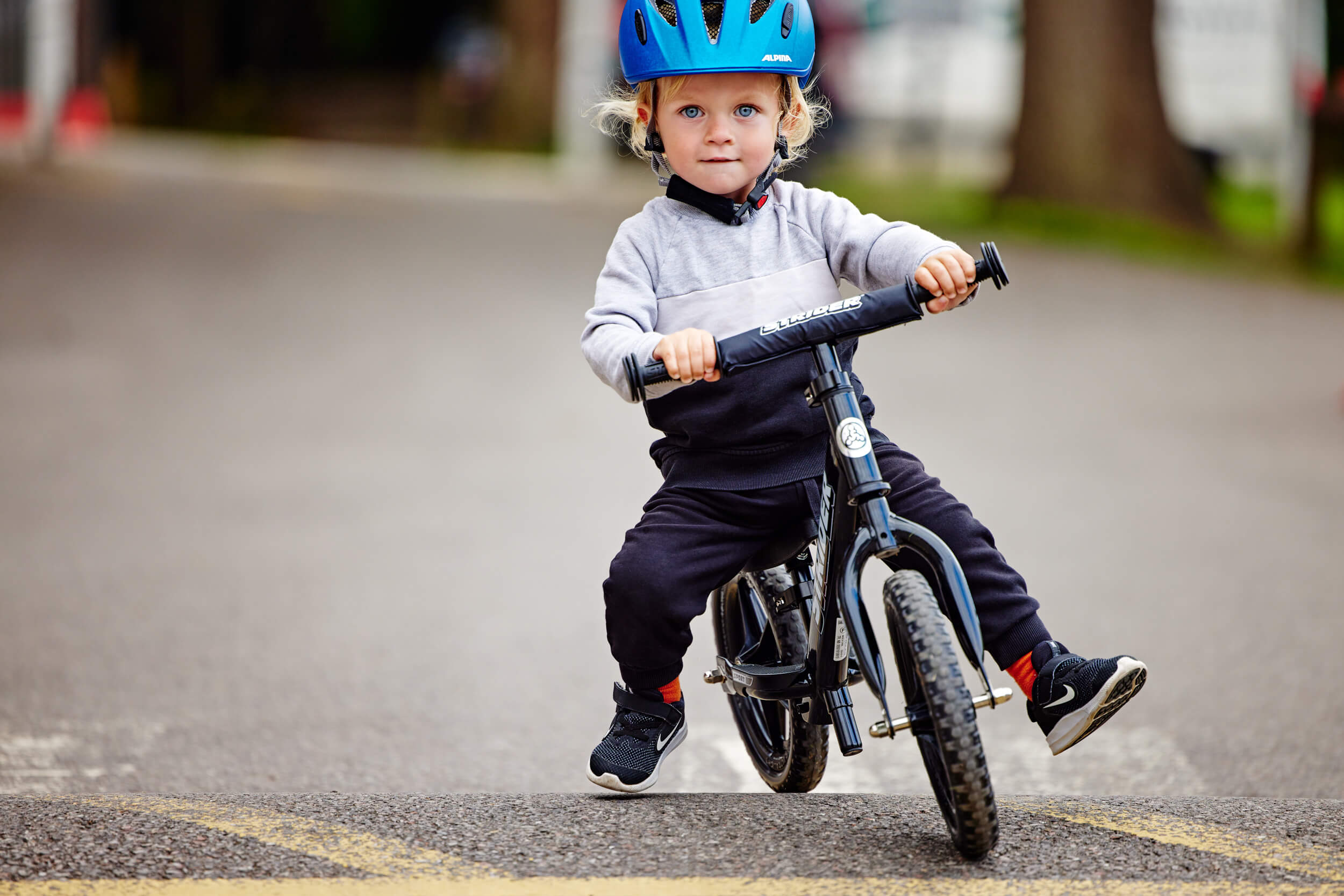 boy riding a balance bike - bike club