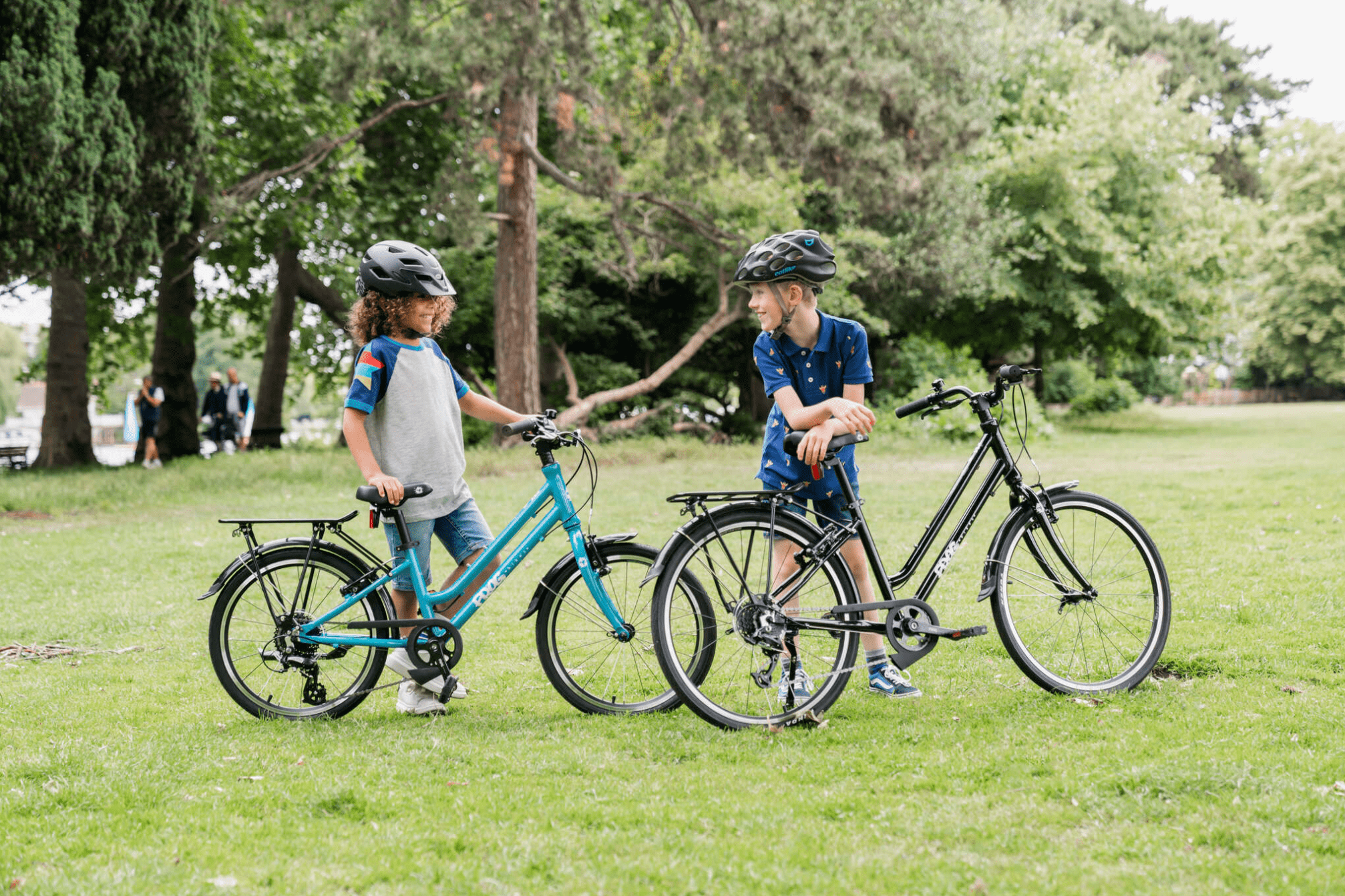 2 children with Frog City Bikes in the park