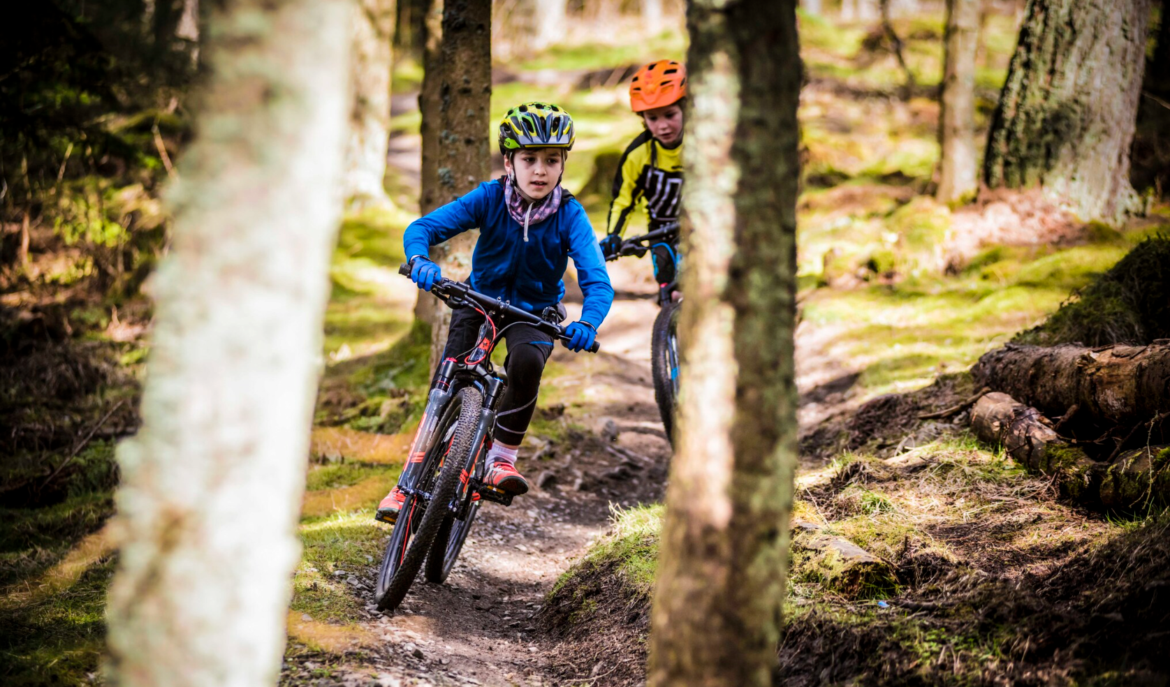 two kids riding downhill on bikes - Bike Club