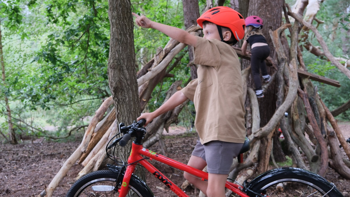 child on bike pointing