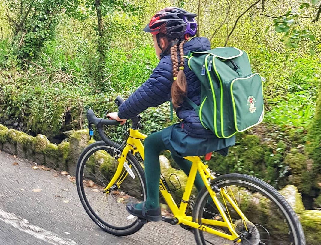 girl on yellow bike