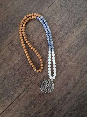 Snow quartz, sodalite and sandalwood strung along a handmade mala necklace for balance, made in Kamloops, BC.