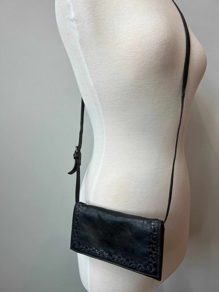 Black leather Carisa wallet and crossbody bag on mannequin
