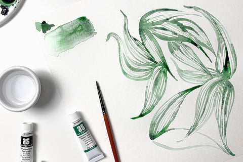 Watercolour painted green leaves on white background with paint tubes and paintbrush