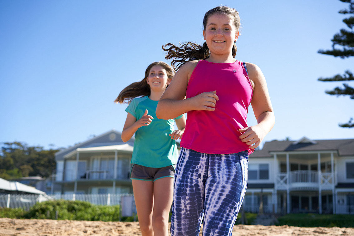 girls running on beach