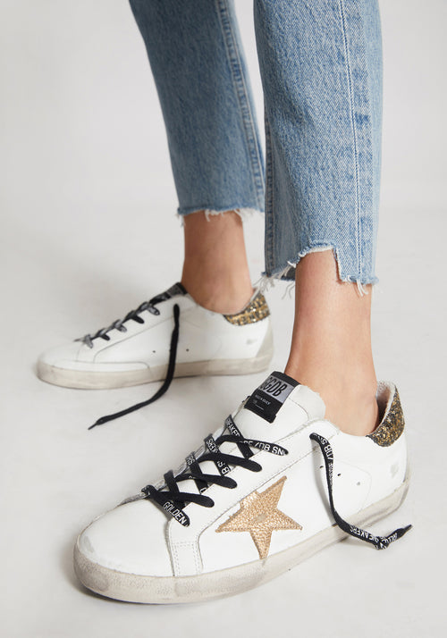 white sneakers with gold stars