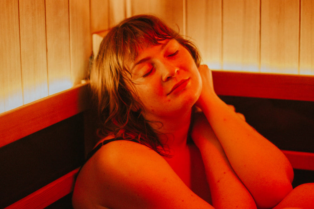 Woman resting in the sauna with her eyes closed