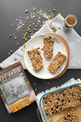 image of teff granola bars on a plate beside a bag of brown teff grains