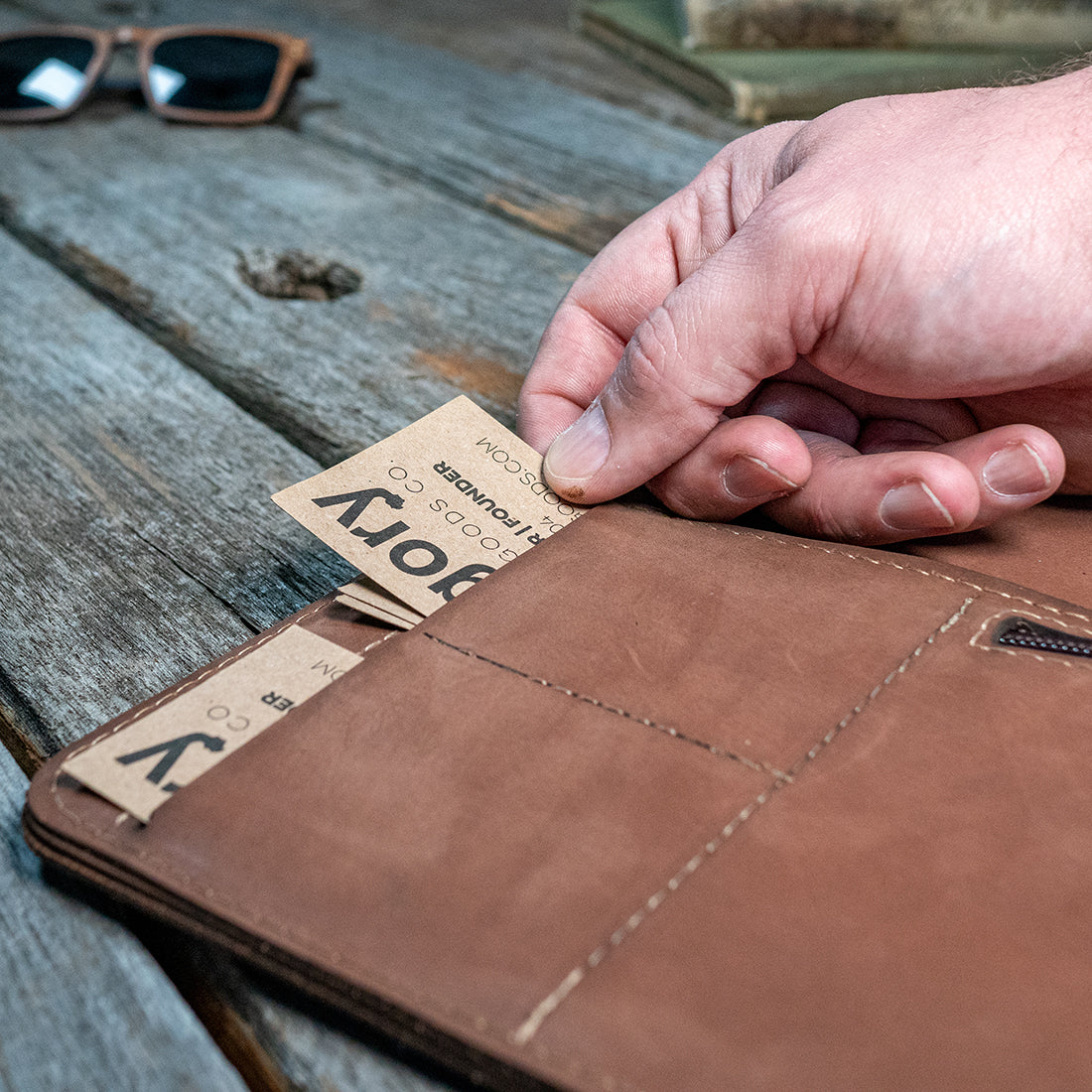 hand pulling business cards out of pocket