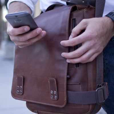 Front cover of bag not tucked into strap.