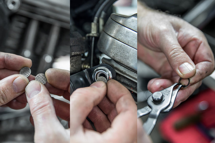 Using snap ring pliers insert the snap rings into each breather bolt