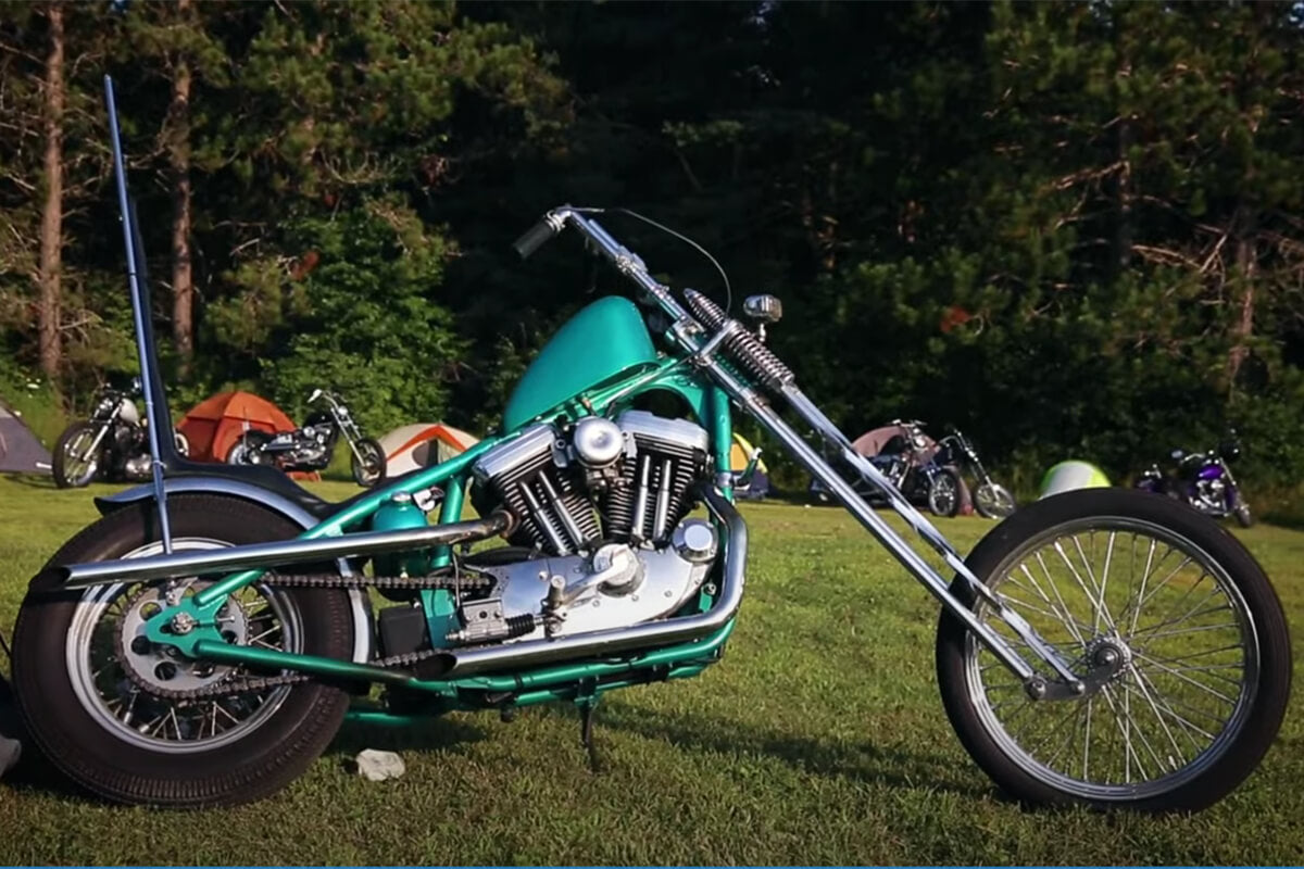 A long, raked out hardtail Harley Sportster on the Apocalypse run. Check out that sissy bar!