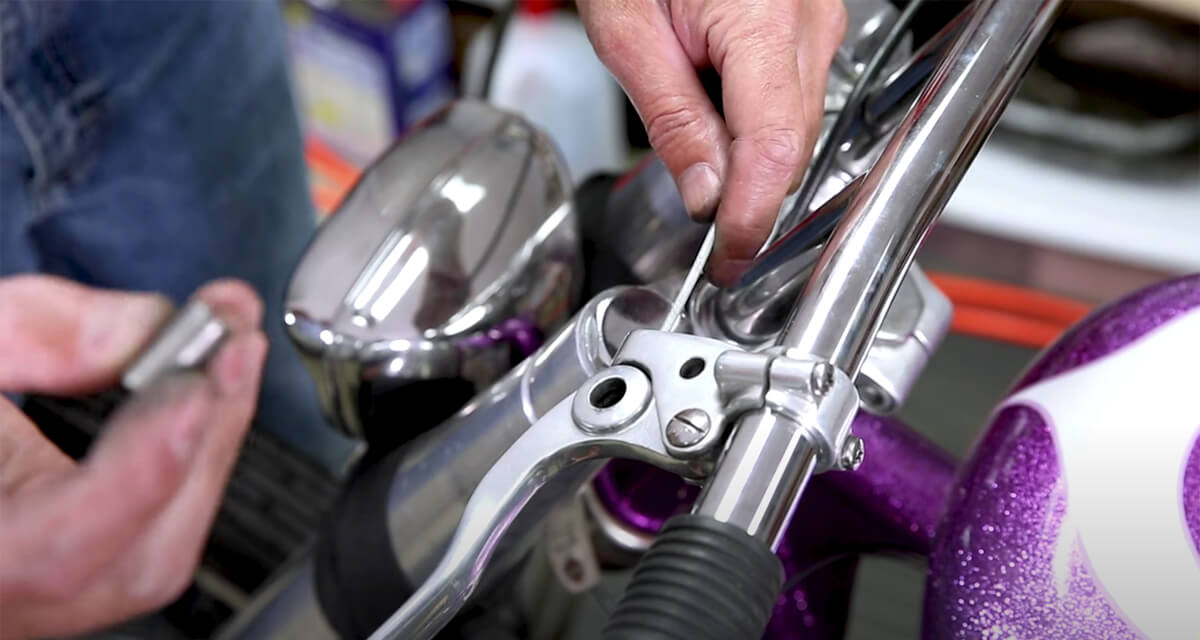 Installing the new Harley Shovelhead clutch cable on the clutch lever.