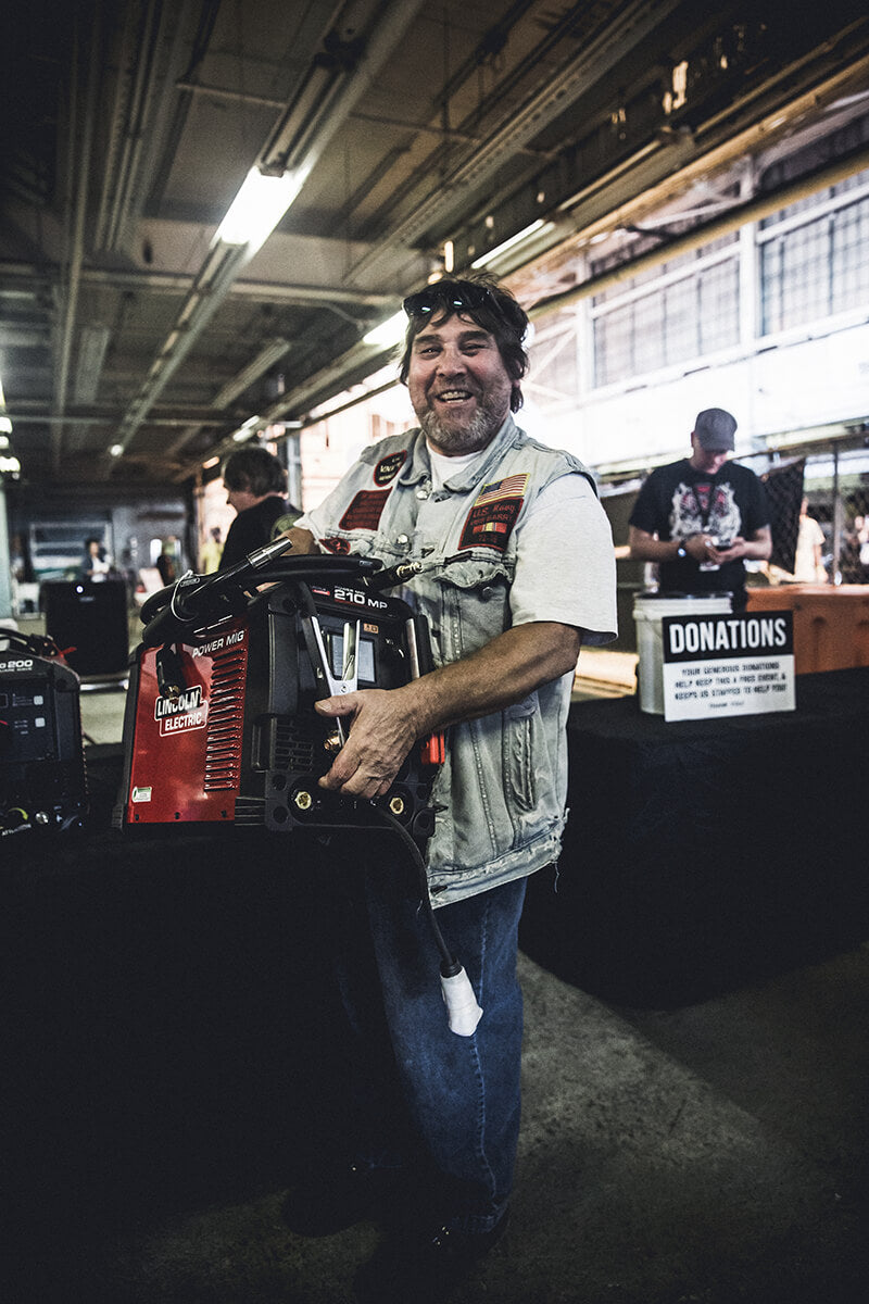 Jeff got a call while he was in the parking lot that he won a Lincoln Electric Mig Welder. He couldn't believe it! Fuel Cleveland 2017 - Lowbrow Customs, The Gasbox, Forever The Chaos Life
