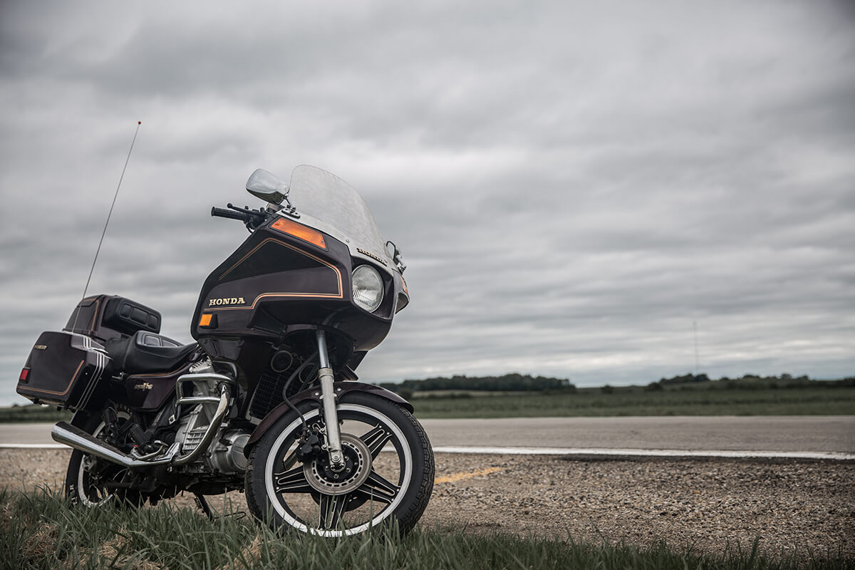 The lone Honda Silverwing all on its own, no owner in sight and just staring into the clouds. - Lowbrow Customs - Sturgis 2017