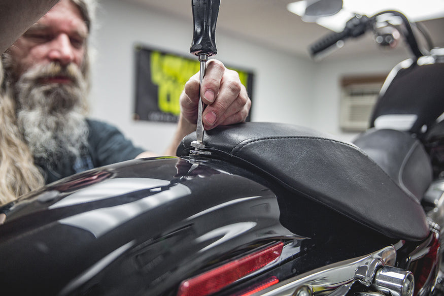 Todd removing seat screw from fender. Lowbrow Customs, How to install Le Pera Seat and Gasbox Sissybar - Sportster