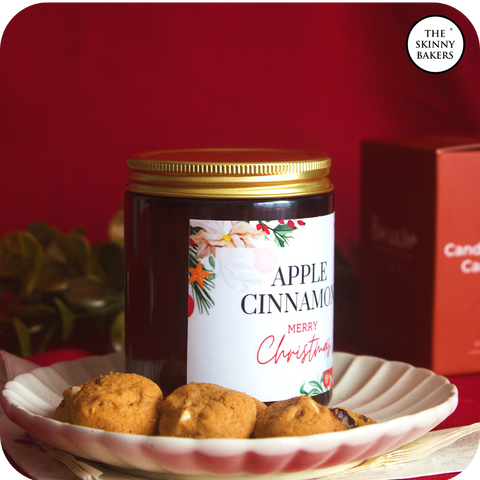 Image shows Oh Lilin's Apple Cinnamon Christmas Candle along with a few pieces of our Cranberry White Chocolate Chip Cookies