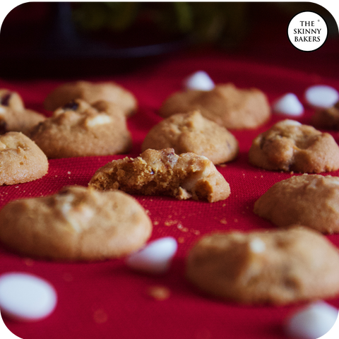 Image shows several pieces of The Skinny Bakers' Cranberry White Chocolate Chip Cookies.