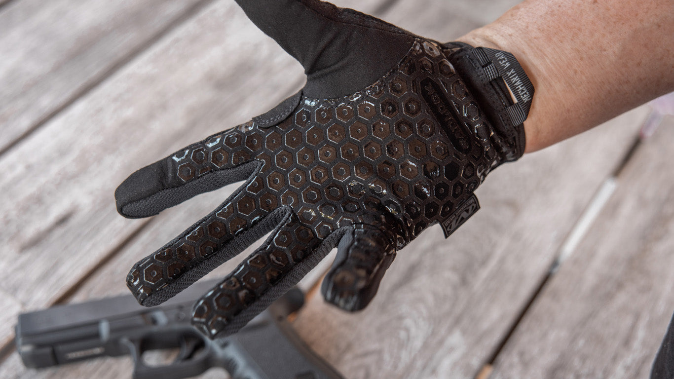 Mechanix Wear Covert Tactical Gloves worn while handling a firearm, emphasizing the glove's Padlock™ grip technology for secure weapon manipulation.