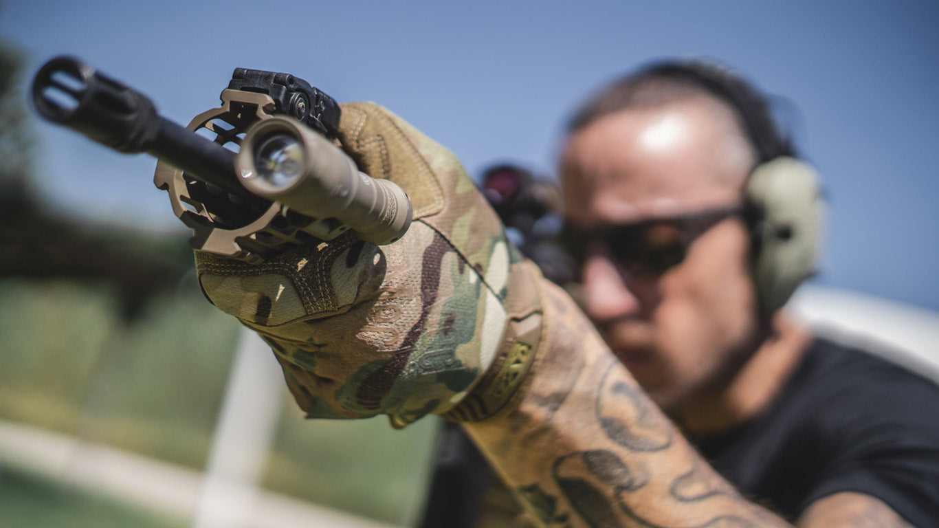 Close-up of a shooter's hands in Mechanix Wear The Original Multicam Tactical Gloves, highlighting the glove's functionality and fit.