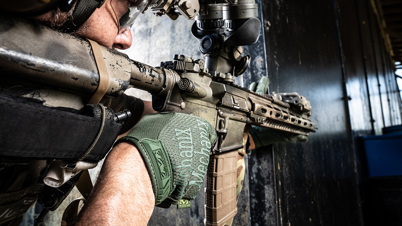 Close-up of a shooter's hands in Mechanix Wear The Original Multicam Tactical Gloves, highlighting the glove's functionality and fit.