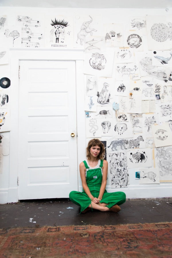 Nashville artist Emily Miller sitting in her studio. 